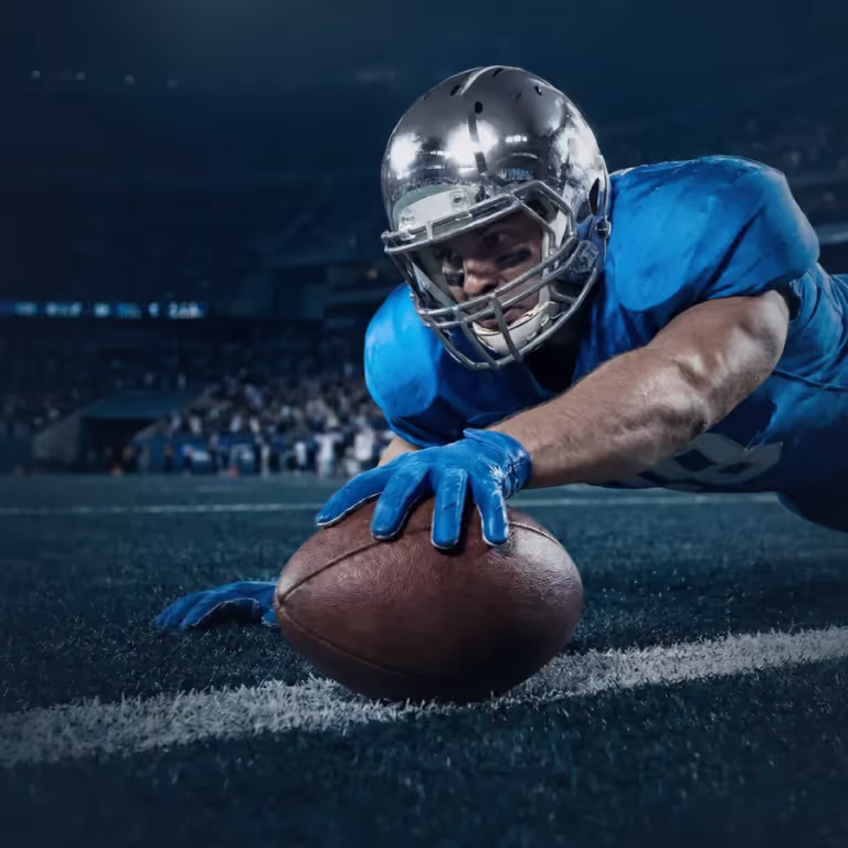 An American football player diving for a touchdown, representing fast deposit and payment options at OxiBet.